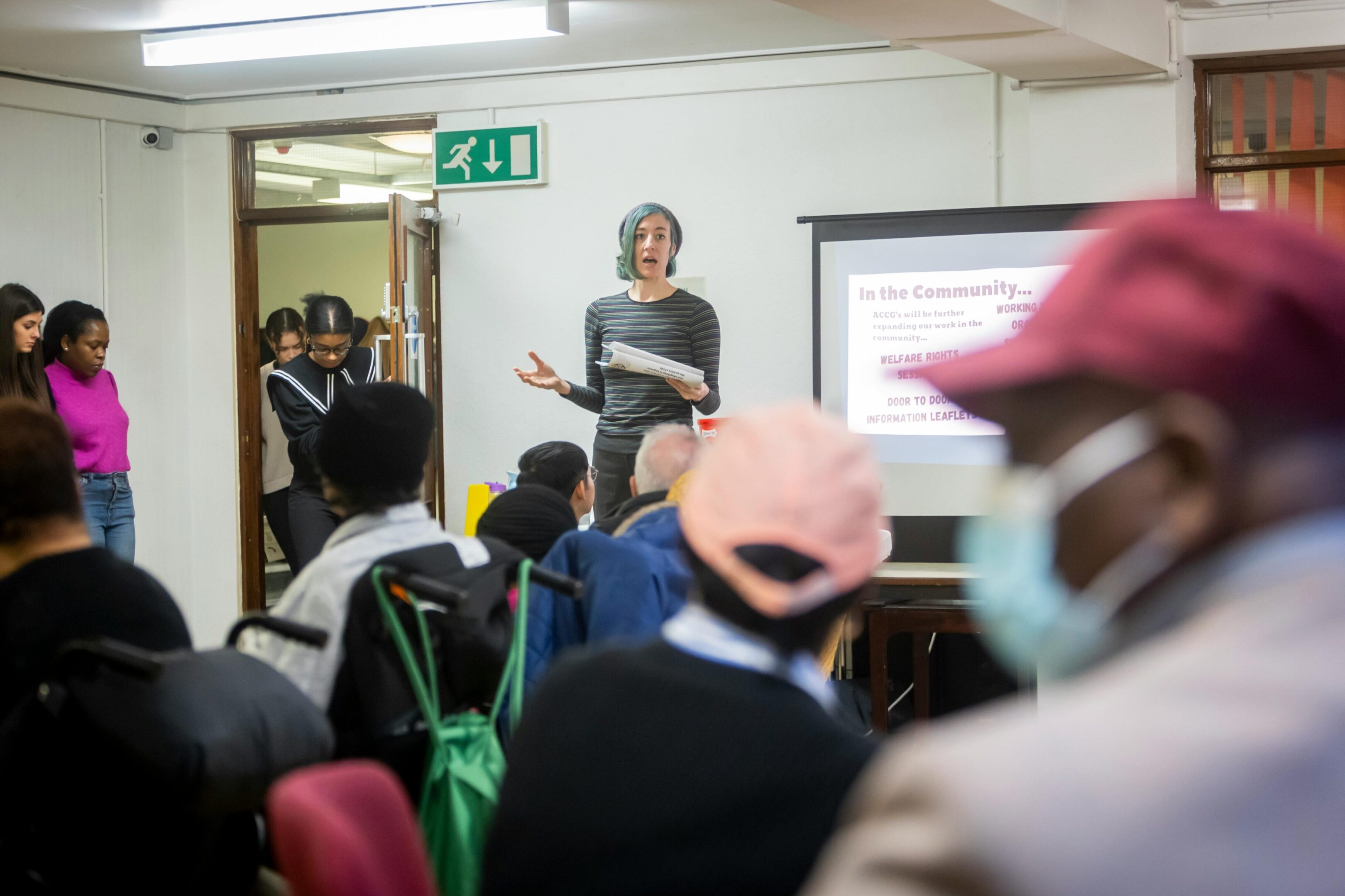 A speaker presents to an attentive audience in a classroom setting.